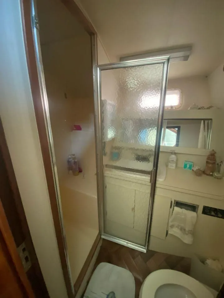 Slide: The Image of Bathroom interior of 1987 Hatteras 40 Double Cabin yacht with shower and vanity. - 12