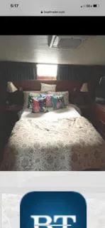 Slide: The Image of Cozy bedroom in 1987 Hatteras 40 Double Cabin yacht with decorative pillows and elegant bedding. - 6