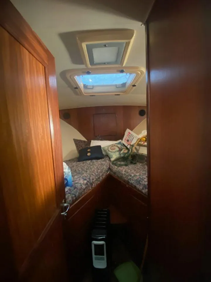 Slide: The Image of 1987 Hatteras 40 Double Cabin interior with cozy bedding and wooden finish. - 7
