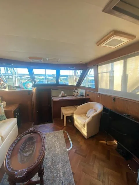 Slide: The Image of Interior of 1987 Hatteras 40 Double Cabin with elegant seating and wood accents. - 9