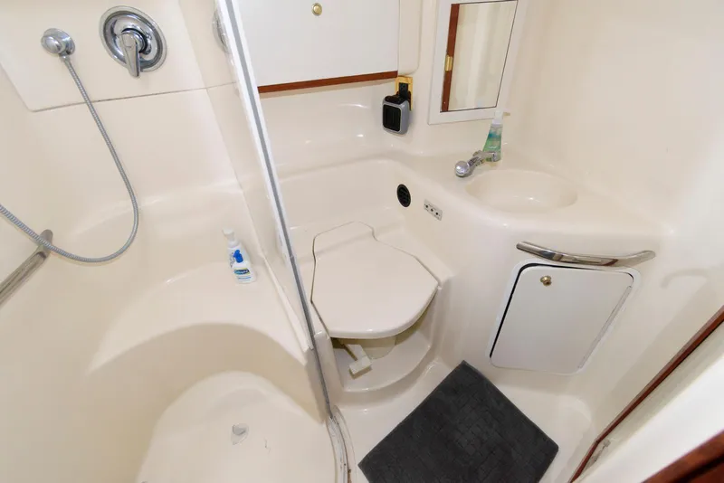 Slide: The Image of Bathroom interior of 1998 Sea Ray 450 Sundancer yacht, featuring shower and sink. - 13