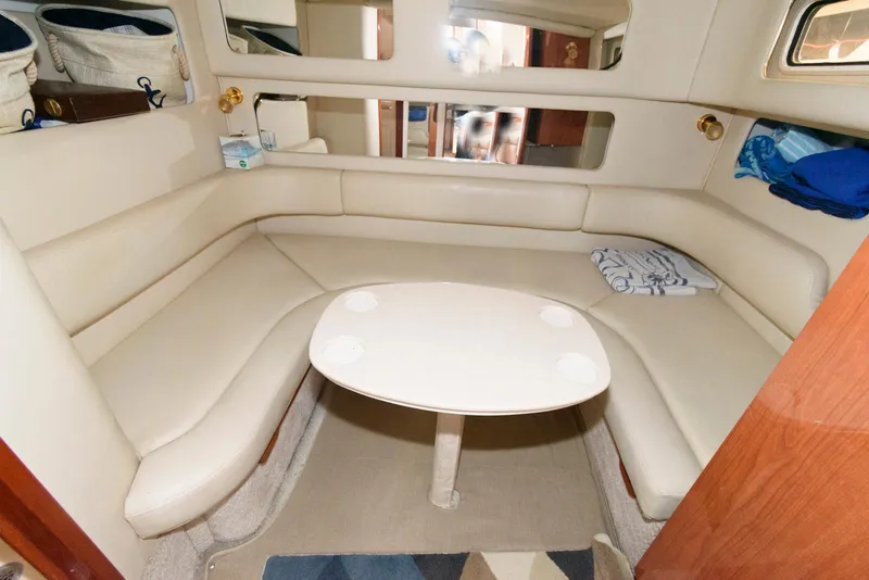 Slide: The Image of 1998 Sea Ray 450 Sundancer interior with beige seating and table. - 14