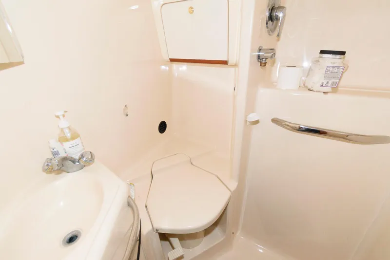 Slide: The Image of Bathroom interior of 1998 Sea Ray 450 Sundancer yacht, featuring sink and toilet. - 15