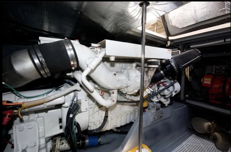 Slide: The Image of Engine room of 1998 Sea Ray 450 Sundancer yacht, showcasing mechanical components. - 16