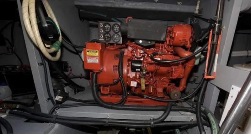Slide: The Image of Engine compartment of 1998 Sea Ray 450 Sundancer boat, featuring red machinery and cables. - 18