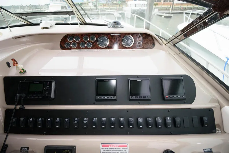 Slide: The Image of 1998 Sea Ray 450 Sundancer helm with navigation instruments and control panel. - 7