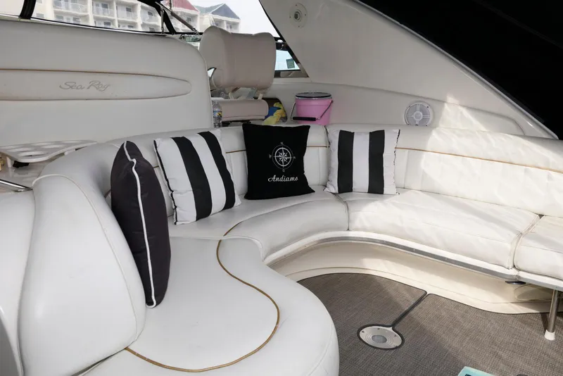 Slide: The Image of Interior of 1998 Sea Ray 450 Sundancer with white seating and decorative pillows. - 8