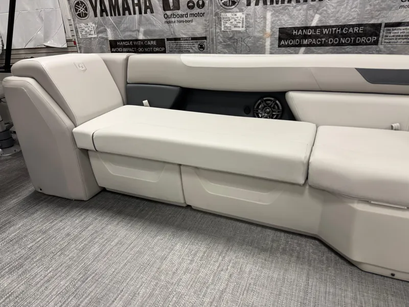 Slide: The Image of 2025 Godfrey Sweetwater Entertainment boat interior with beige seating and Yamaha branding. - 12