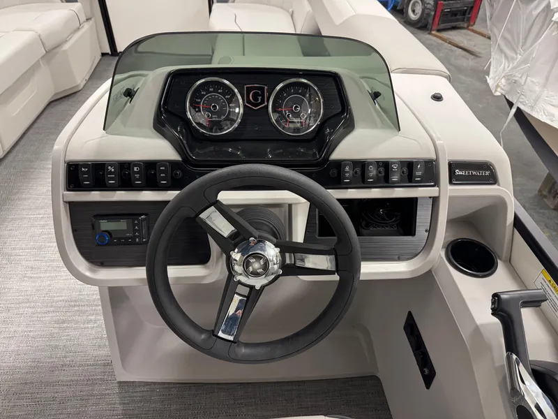 Slide: The Image of 2025 Godfrey Sweetwater Entertainment boat dashboard with steering wheel and instrument panel. - 14