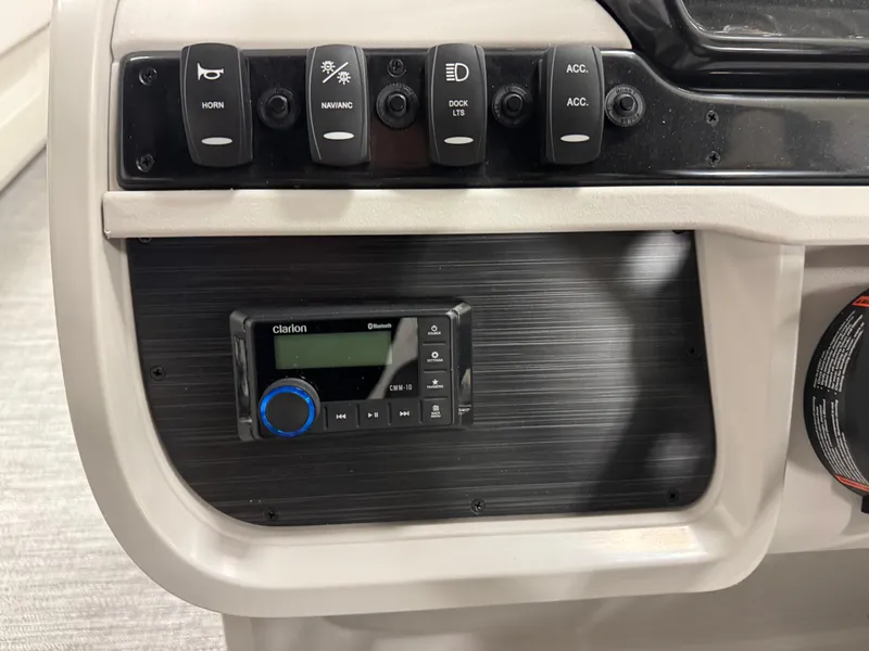 Slide: The Image of Control panel of 2025 Godfrey Sweetwater Entertainment boat with switches and Clarion audio system. - 16