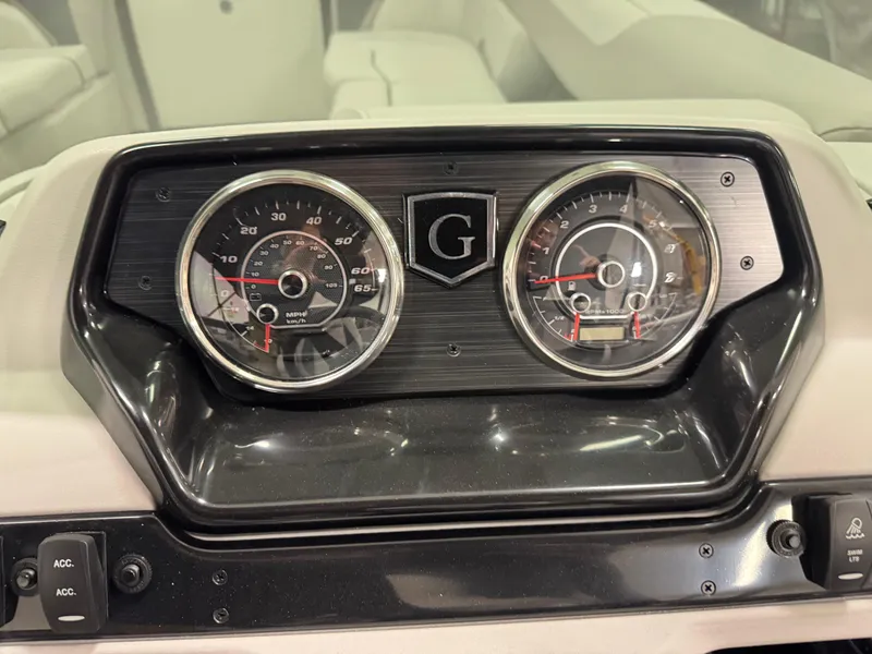 Slide: The Image of Dashboard of 2025 Godfrey Sweetwater Entertainment boat with dual gauges and controls. - 17