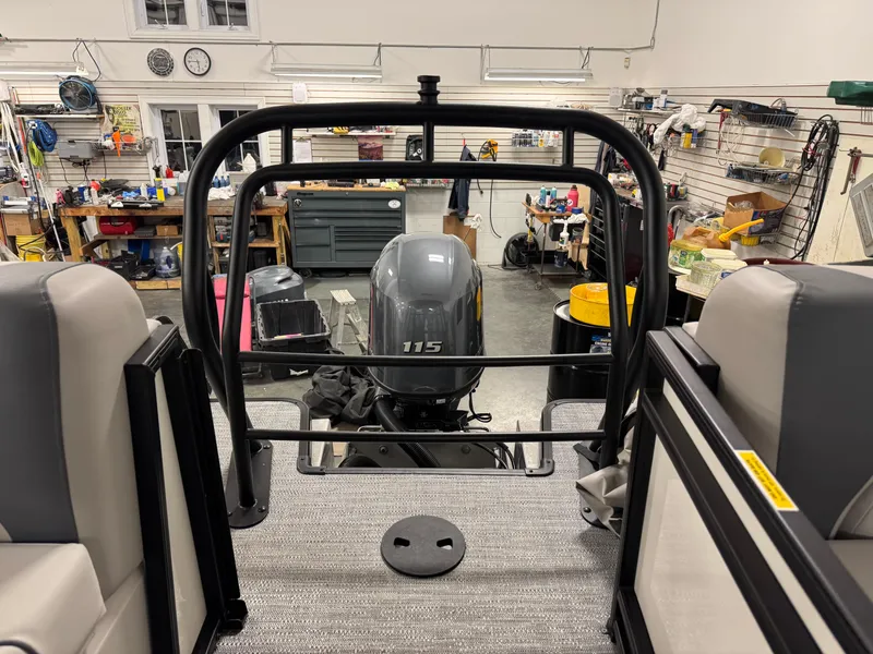 Slide: The Image of 2025 Godfrey Sweetwater Entertainment boat with 115 HP engine in a workshop setting. - 27