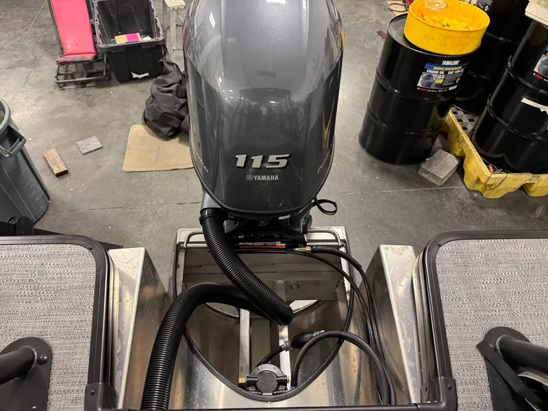 Slide: The Image of Outboard motor on a 2025 Godfrey Sweetwater Entertainment boat in a workshop setting. - 28