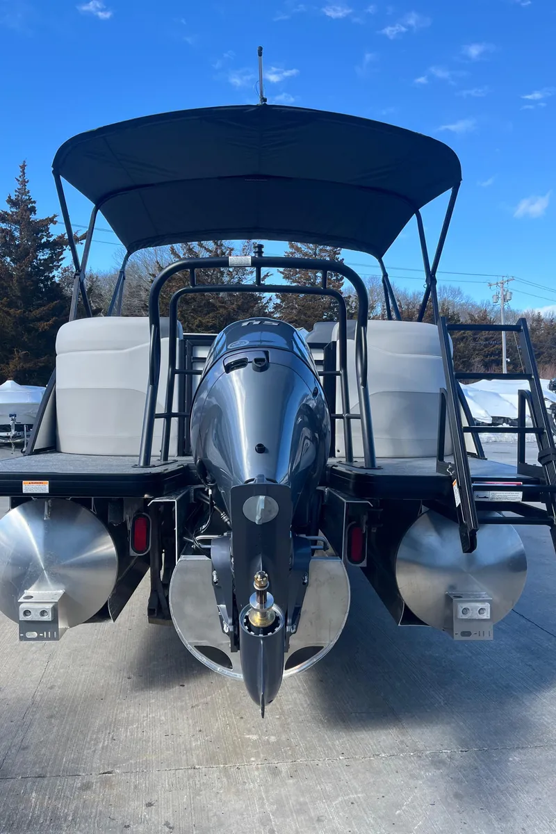 Slide: The Image of 2025 Godfrey Sweetwater Entertainment pontoon boat with canopy and outboard motor, rear view. - 5