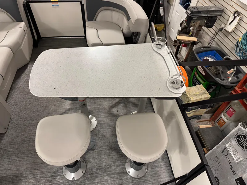 Slide: The Image of Interior of 2025 Godfrey Sweetwater Entertainment boat with table and seating arrangement. - 7