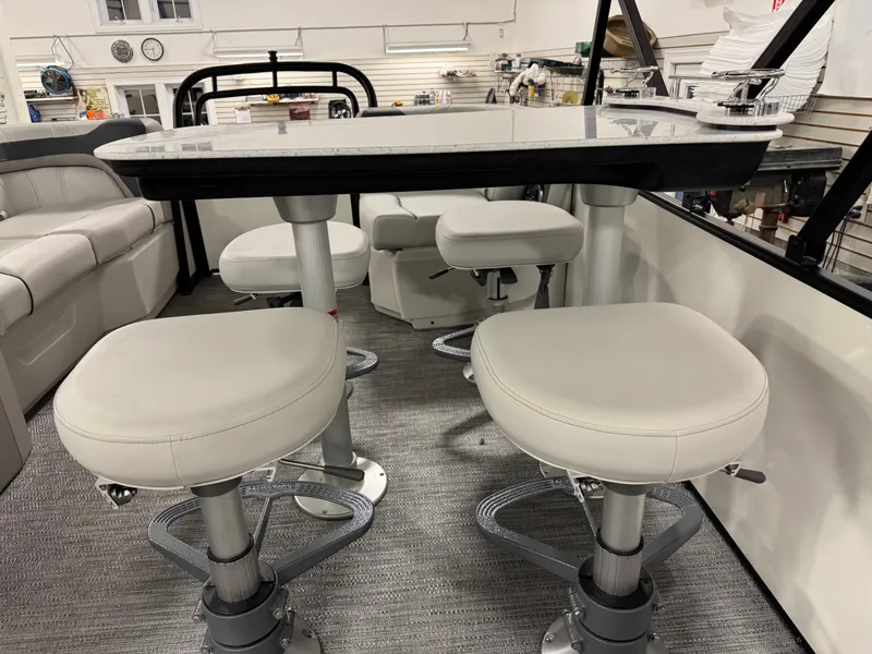 Slide: The Image of 2025 Godfrey Sweetwater Entertainment boat interior with modern seating and table setup. - 8