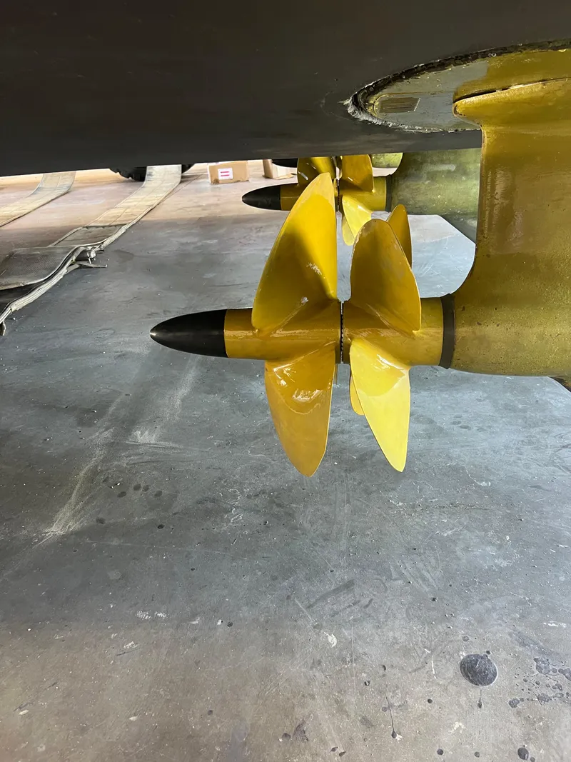 Slide: The Image of Yellow propellers of a 2008 Ovation 52 boat in a workshop setting. - 11