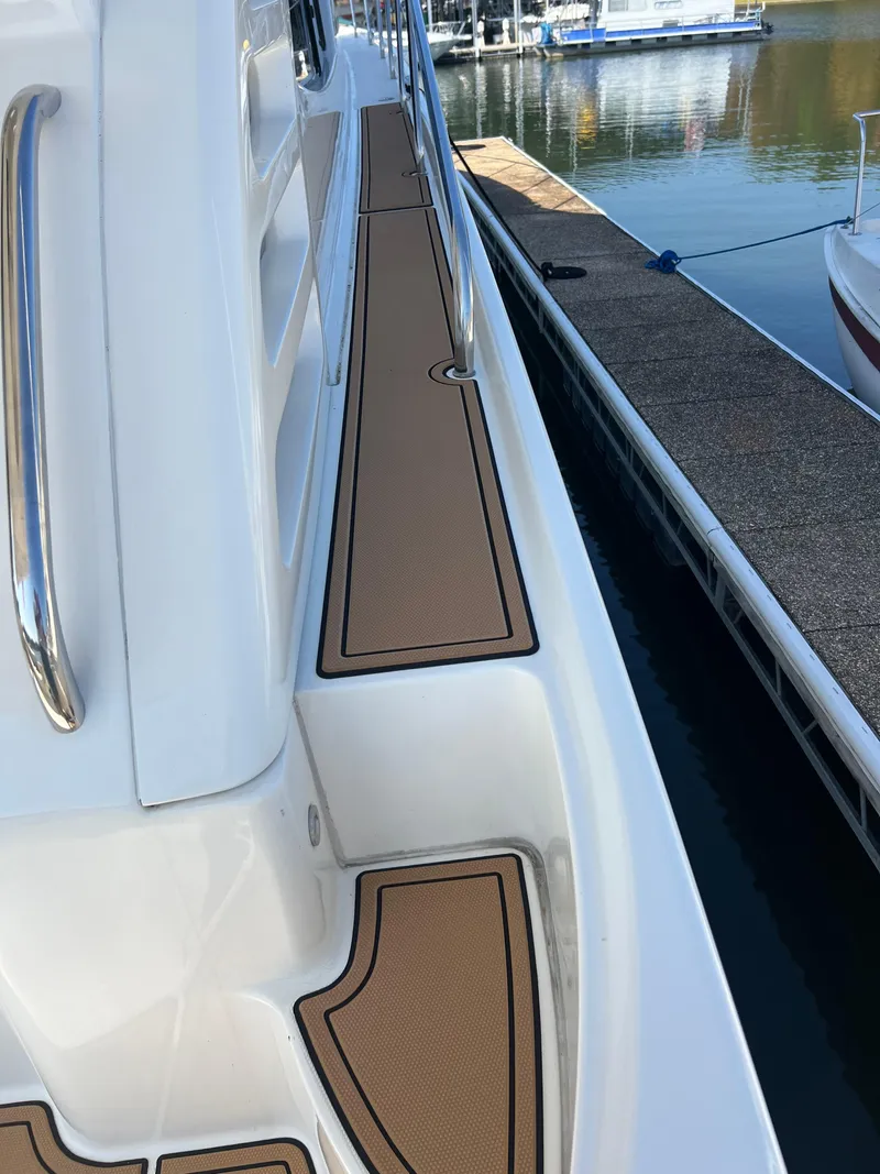 Slide: The Image of 2008 Ovation 52 yacht deck with brown non-slip surface, docked at marina. - 16