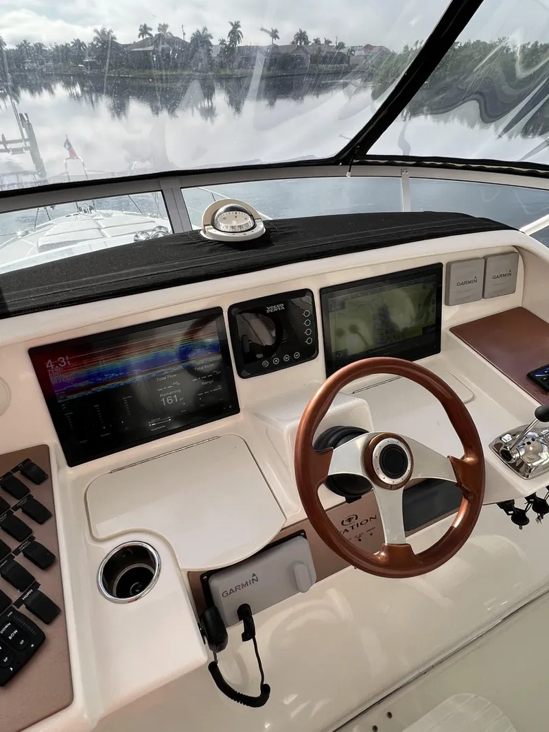 Slide: The Image of Helm of 2008 Ovation 52 yacht with modern navigation equipment and wooden steering wheel. - 18