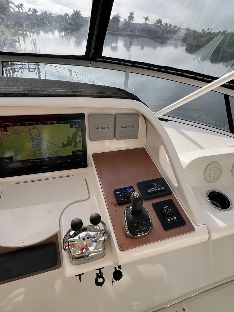 Slide: The Image of Control panel of a 2008 Ovation 52 yacht with navigation display and joystick. - 19