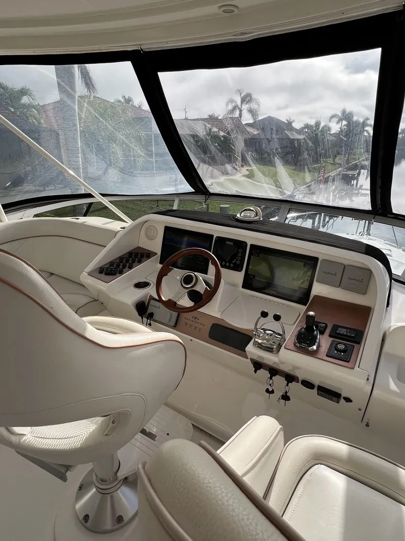 Slide: The Image of Interior of a 2008 Ovation 52 yacht cockpit with steering wheel and navigation controls. - 20