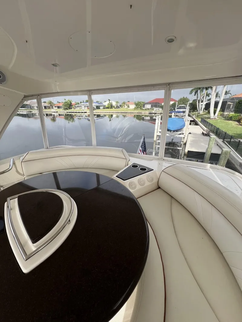 Slide: The Image of Luxurious 2008 Ovation 52 yacht interior with plush seating and scenic marina view. - 21