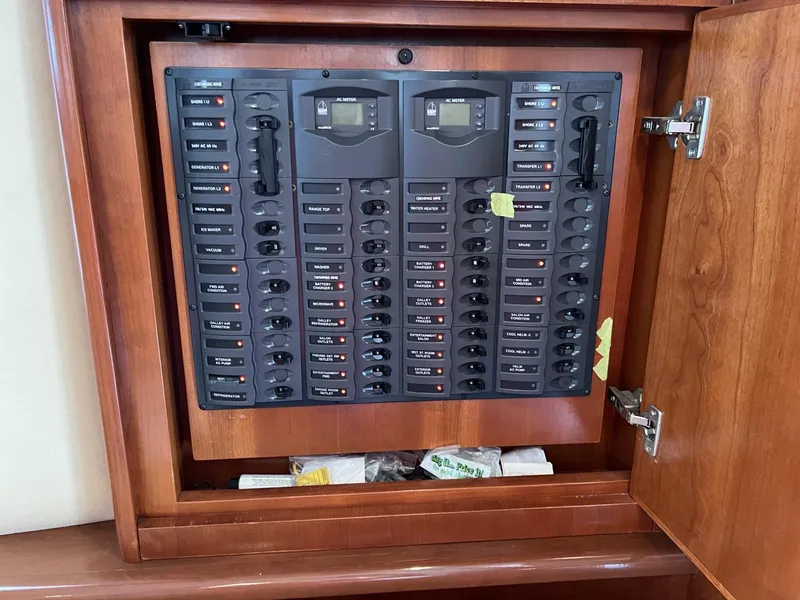 Slide: The Image of Electrical panel inside wooden cabinet on a 2008 Ovation 52 yacht. - 30