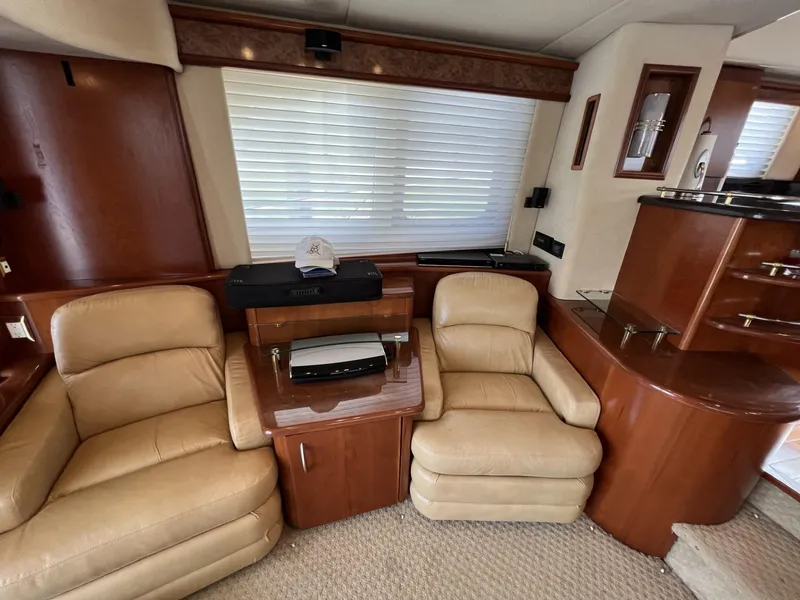 Slide: The Image of Luxurious 2008 Ovation 52 yacht interior with beige leather seating and wooden accents. - 34