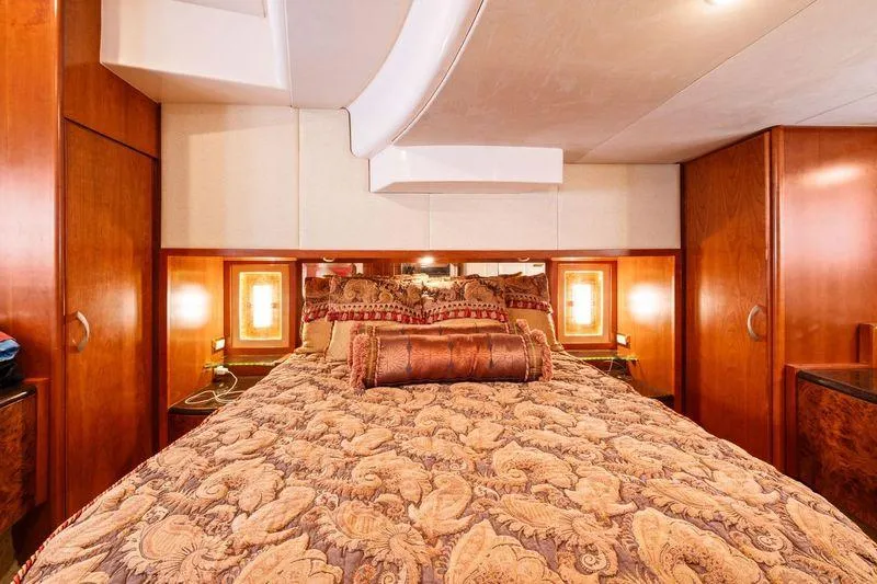 Slide: The Image of Luxurious bedroom interior in a 2008 Ovation 52 yacht, featuring elegant wood finishes. - 43