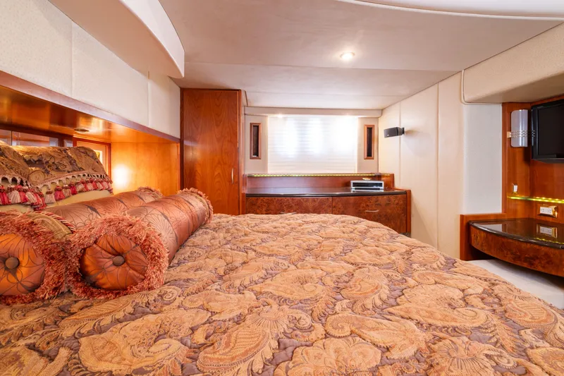 Slide: The Image of Luxurious bedroom interior in 2008 Ovation 52 yacht, featuring elegant bedding and wood accents. - 46