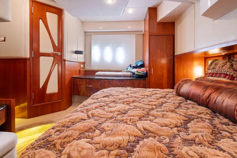Slide: The Image of Luxurious bedroom interior in 2008 Ovation 52 yacht, featuring elegant wood finishes and plush bedding. - 47