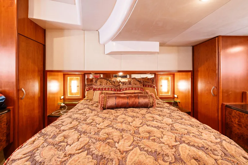 Slide: The Image of Luxurious bedroom interior in 2008 Ovation 52 yacht with elegant bedding and warm lighting. - 53
