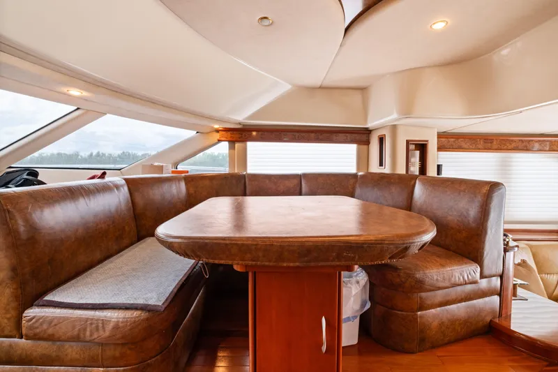 Slide: The Image of Luxurious interior of 2008 Ovation 52 yacht with leather seating and wooden table. - 54