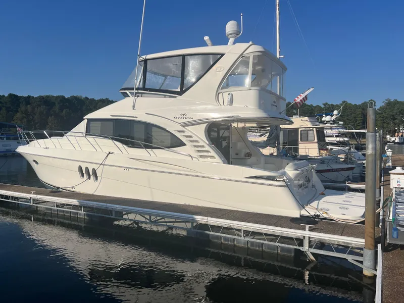Slide: The Image of 2008 Ovation 52 yacht docked at a marina under clear blue skies. - 8