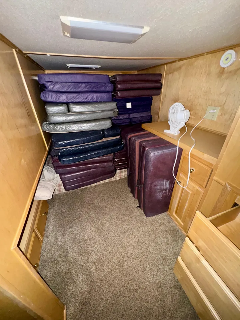 Slide: The Image of Stacked cushions in a compact wooden room with a small fan, Fantasy Escape From LA 2000. - 14