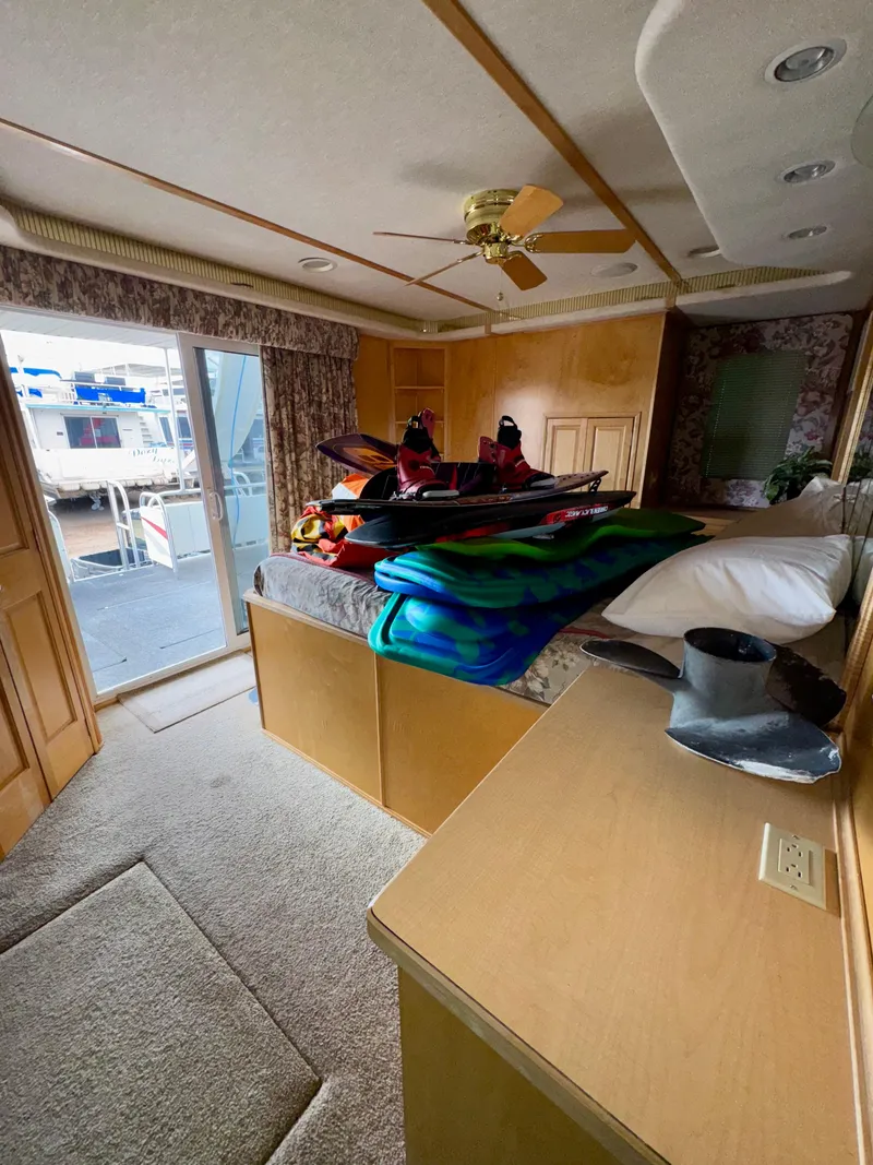 Slide: The Image of Cozy bedroom in 2000 Fantasy Escape From LA houseboat with colorful blankets and ceiling fan. - 15