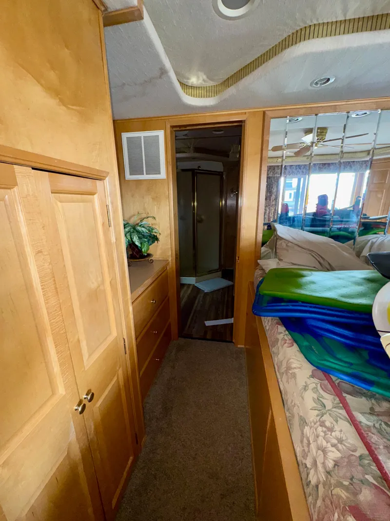 Slide: The Image of Interior of a 2000 Fantasy Escape From LA RV with wood cabinets and mirrored wall. - 16