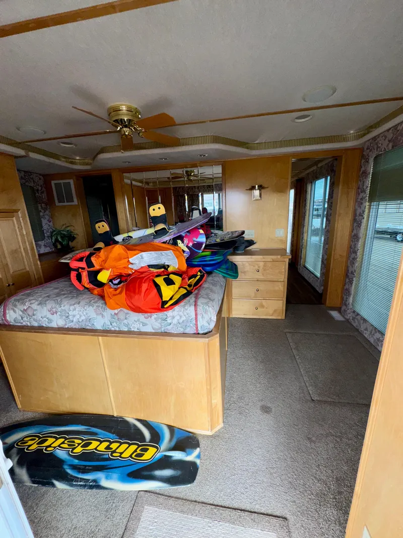 Slide: The Image of Interior of a 2000 Fantasy Escape From LA RV with wakeboards and colorful gear. - 18