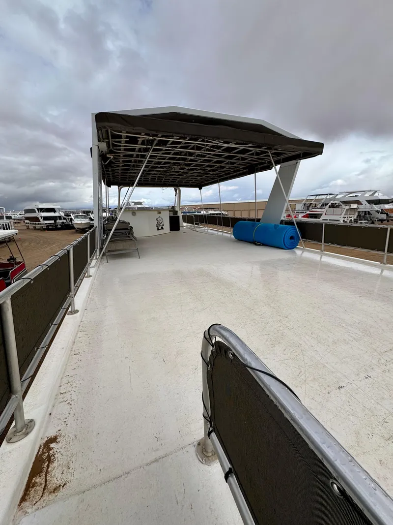 Slide: The Image of Upper deck of a 2000 Fantasy Escape From LA houseboat, featuring a canopy and open space. - 20