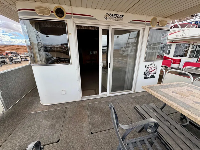 Slide: The Image of Houseboat deck with sliding doors, labeled "Fantasy Escape From LA," featuring outdoor seating. - 3