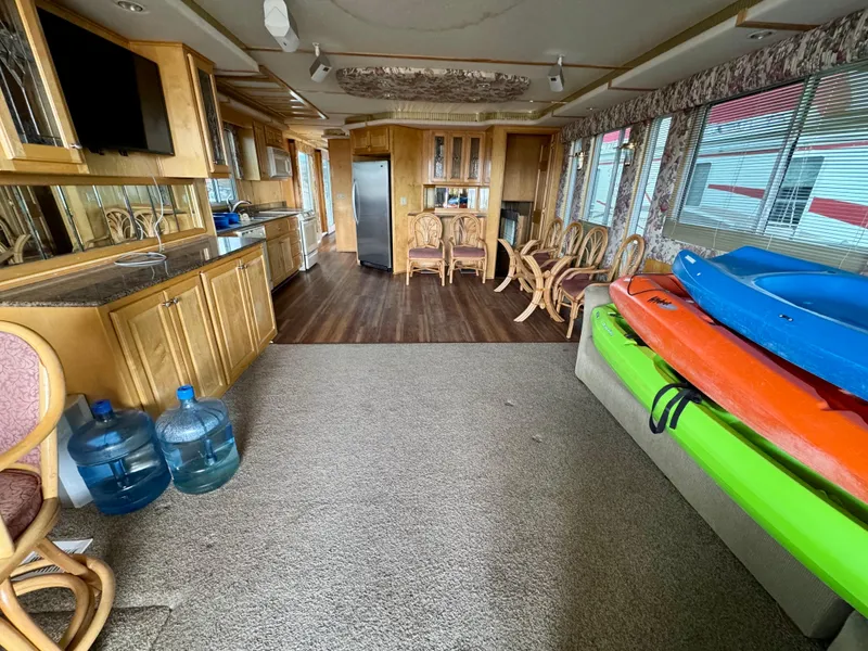 Slide: The Image of Luxurious houseboat interior with kayaks, dining area, and kitchen. Fantasy Escape From LA, 2000 model. - 5