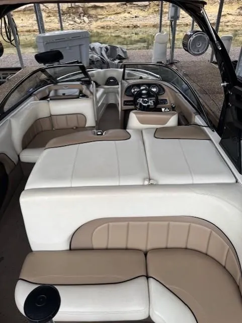 Slide: The Image of 2005 Malibu Sunsetter 23 XTi boat interior with beige and white seating. - 12