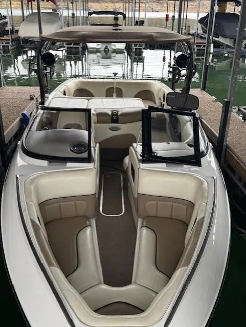 Slide: The Image of 2005 Malibu Sunsetter 23 XTi boat with spacious seating, docked in a marina. - 17