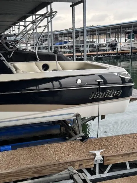 Slide: The Image of 2005 Malibu Sunsetter 23 XTi boat docked in a marina. - 19