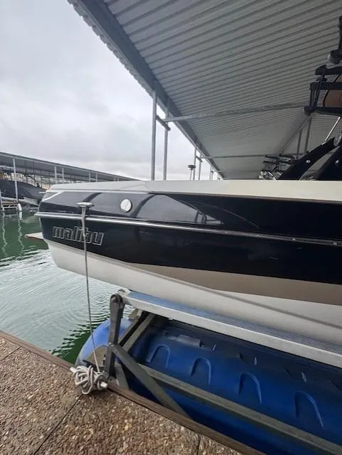 Slide: The Image of 2005 Malibu Sunsetter 23 XTi boat docked under a covered marina. - 21