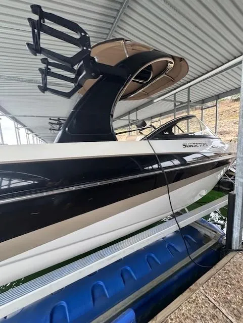 Slide: The Image of 2005 Malibu Sunsetter 23 XTi boat docked under a metal canopy. - 22