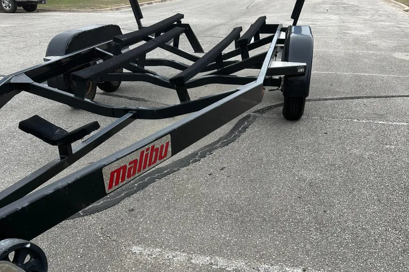 Slide: The Image of Trailer for 2005 Malibu Sunsetter 23 XTi boat in parking lot. - 25