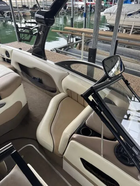 Slide: The Image of 2005 Malibu Sunsetter 23 XTi boat interior with beige seating and sleek design. - 5
