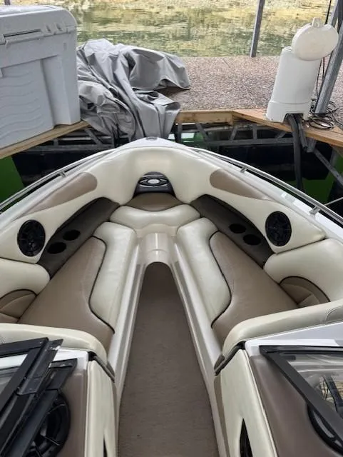 Slide: The Image of 2005 Malibu Sunsetter 23 XTi boat interior with beige seating and speakers. - 6