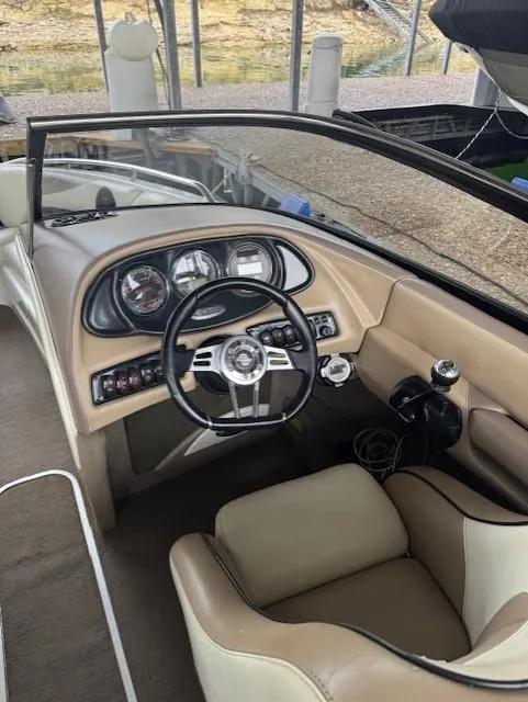 Slide: The Image of 2005 Malibu Sunsetter 23 XTi boat interior with steering wheel and dashboard controls. - 7